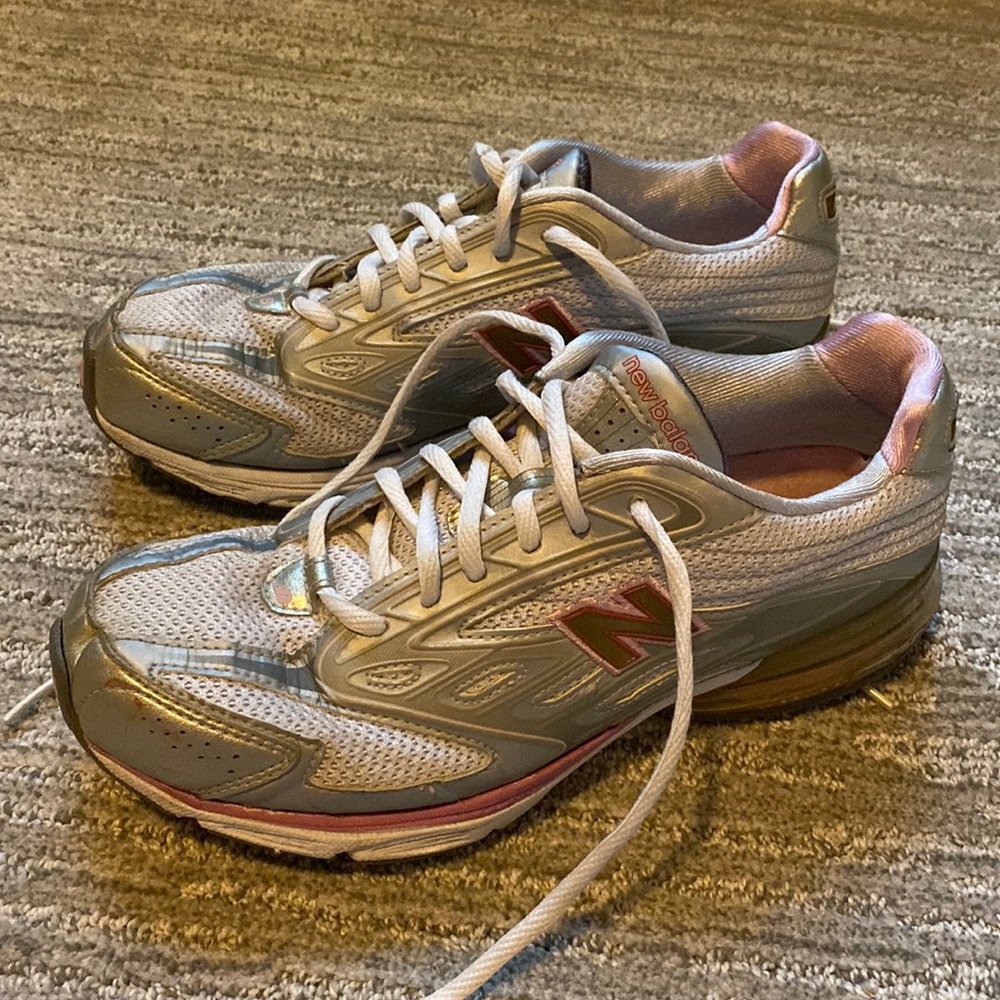 Shoes are grey and silver with hints of pink.